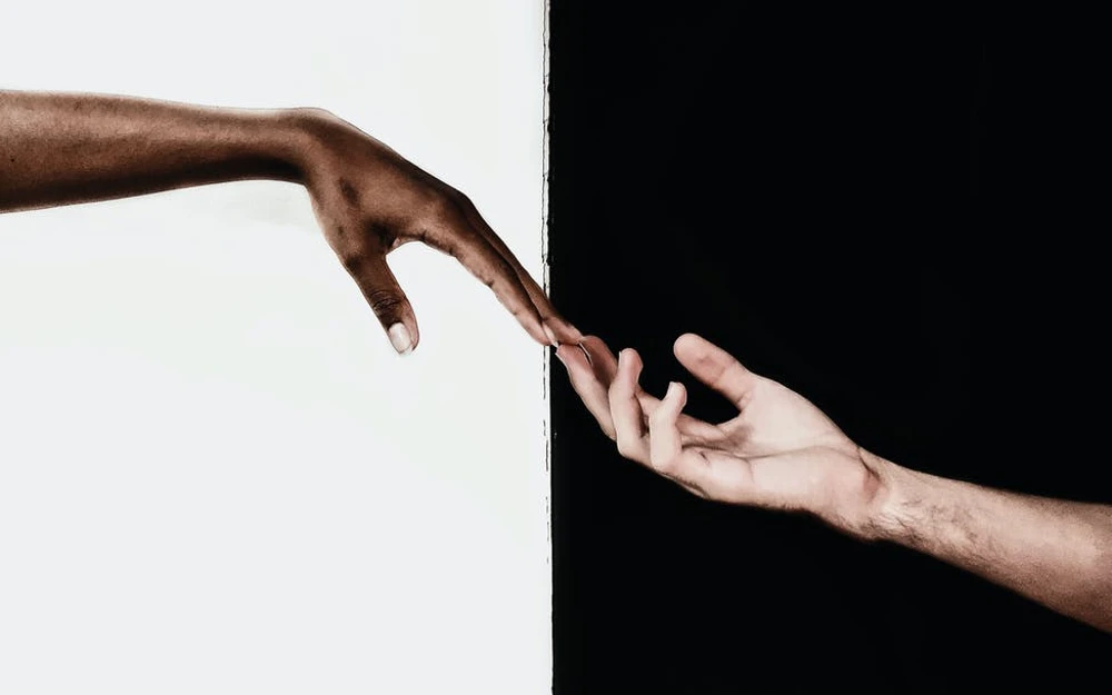 hands in front of white and black background pity