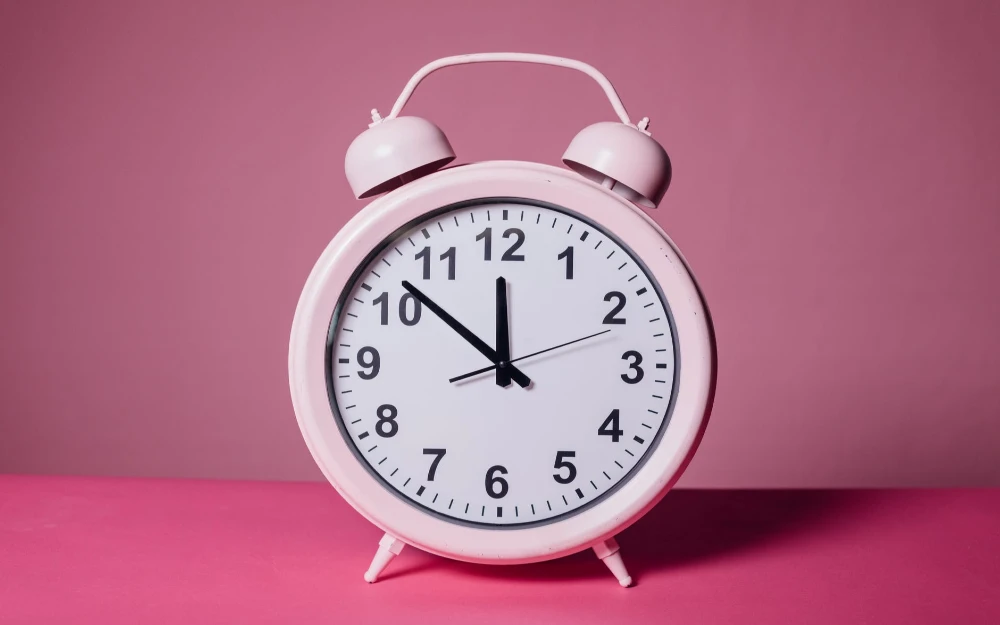 pink alarm clock showing time